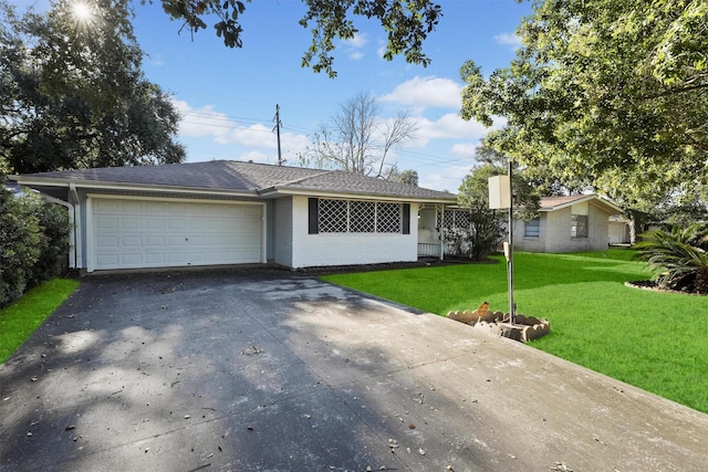 single story home featuring a front lawn and a garage