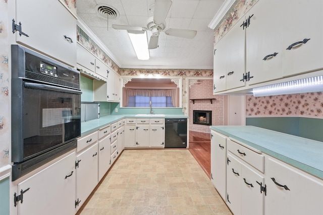 kitchen featuring ceiling fan, black appliances, sink, ornamental molding, and white cabinets