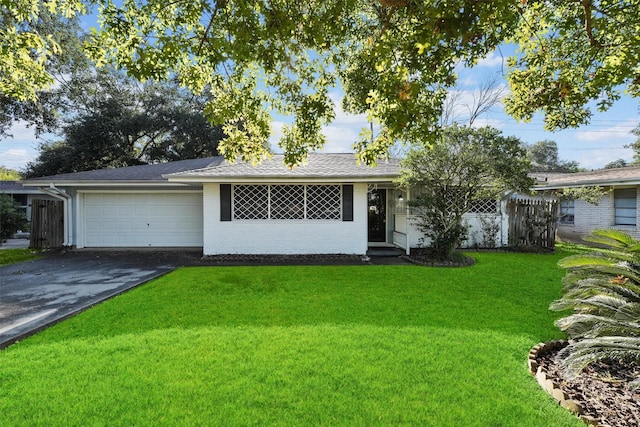 ranch-style home with a front yard and a garage