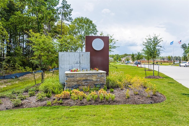 community sign featuring a lawn