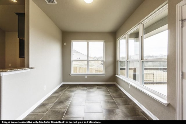 unfurnished sunroom featuring a wealth of natural light