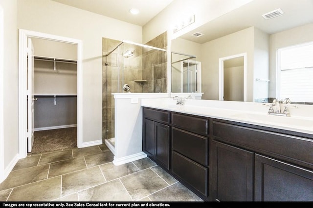 bathroom with a shower with shower door and vanity