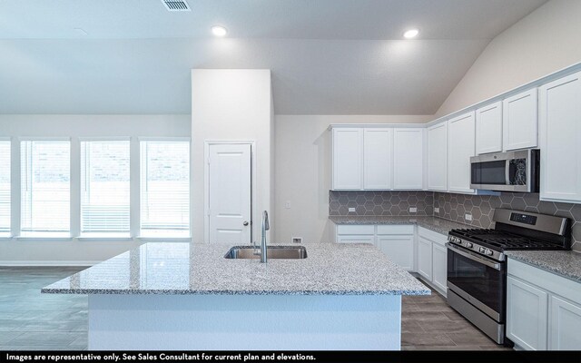 2476 Fairway Harbor Dr, Katy, TX 77493 - kitchen with stainless steel appliances, a sink, light stone counters, tasteful backsplash, and white cabinets