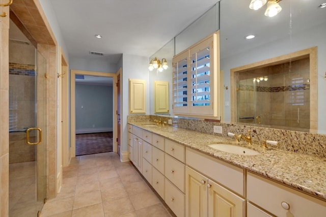 bathroom featuring vanity, tile patterned floors, and a shower with door