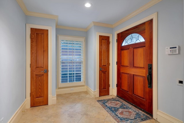 tiled entryway featuring ornamental molding