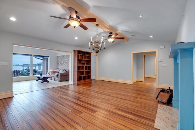 unfurnished living room with lofted ceiling with beams, light wood-type flooring, and ceiling fan with notable chandelier