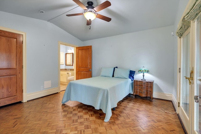 bedroom with vaulted ceiling, ceiling fan, ensuite bathroom, and light parquet flooring