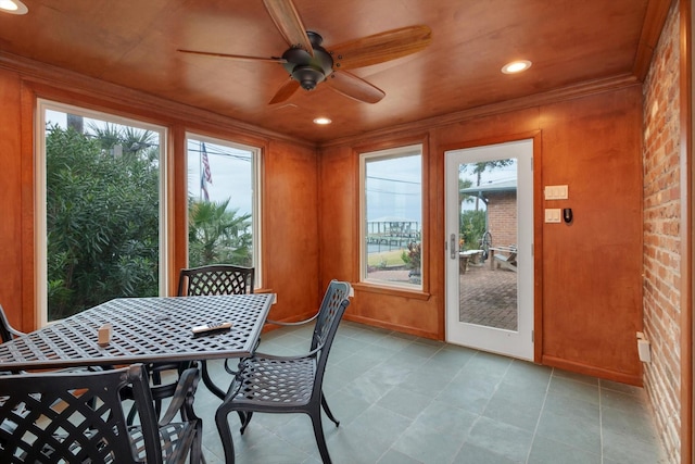 sunroom / solarium with ceiling fan and wooden ceiling