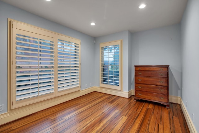 spare room featuring wood-type flooring