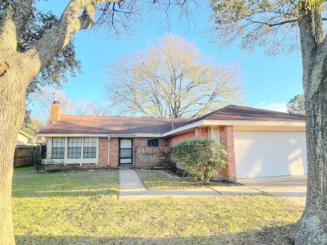 single story home featuring a front lawn and a garage