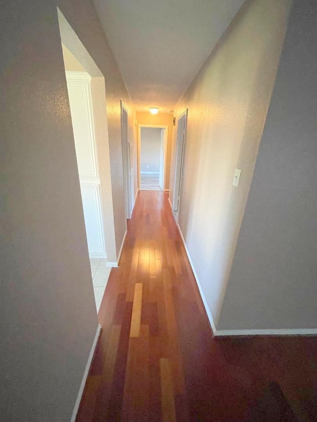 corridor with light hardwood / wood-style flooring