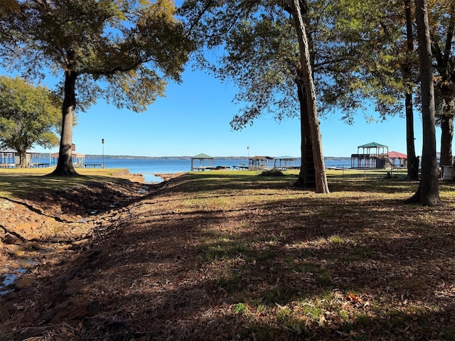 view of yard featuring a gazebo and a water view