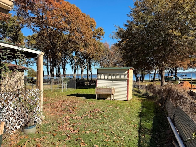 view of yard featuring a shed and a water view