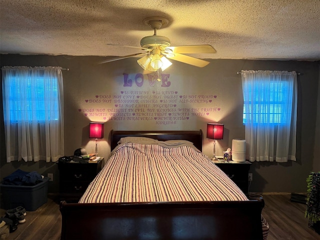 bedroom featuring ceiling fan, a textured ceiling, and wood-type flooring