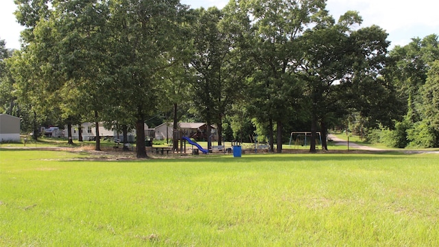 view of home's community featuring a lawn and a playground