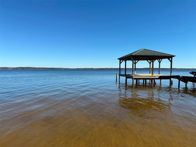 dock area with a gazebo and a water view