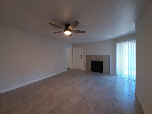 unfurnished living room with ceiling fan and a fireplace