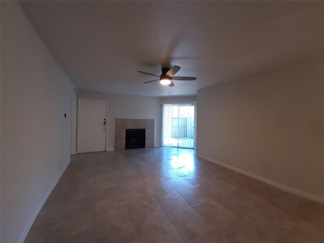 unfurnished living room with ceiling fan, tile patterned floors, and a tile fireplace