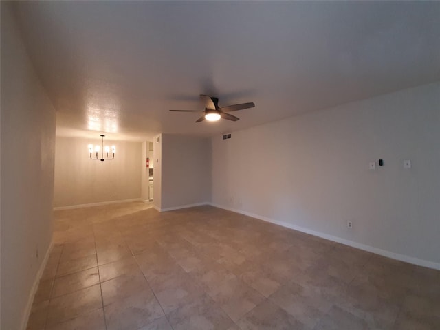 empty room with ceiling fan with notable chandelier