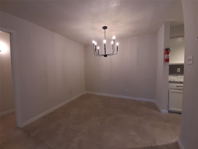 unfurnished dining area with an inviting chandelier