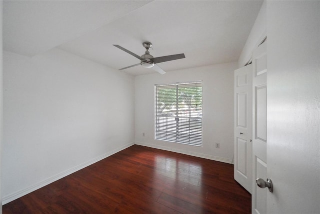 empty room with dark wood-type flooring and ceiling fan