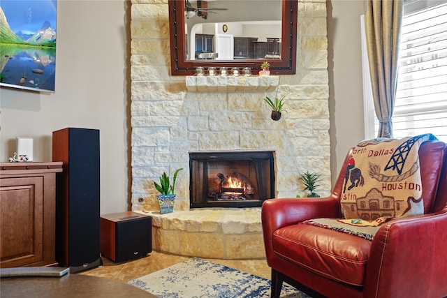 living area featuring a stone fireplace