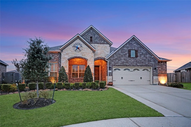 view of front of property featuring a garage and a yard