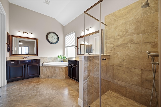 bathroom with vanity, lofted ceiling, and separate shower and tub