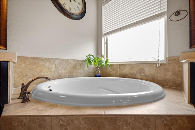 bathroom featuring tiled tub