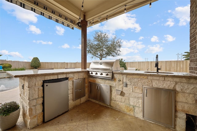 view of patio / terrace with exterior kitchen, sink, and grilling area