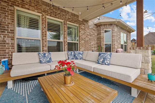 wooden terrace with an outdoor living space