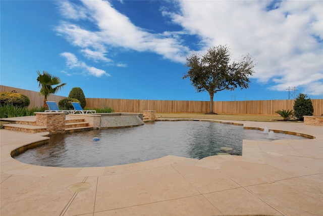 view of swimming pool featuring pool water feature and a patio