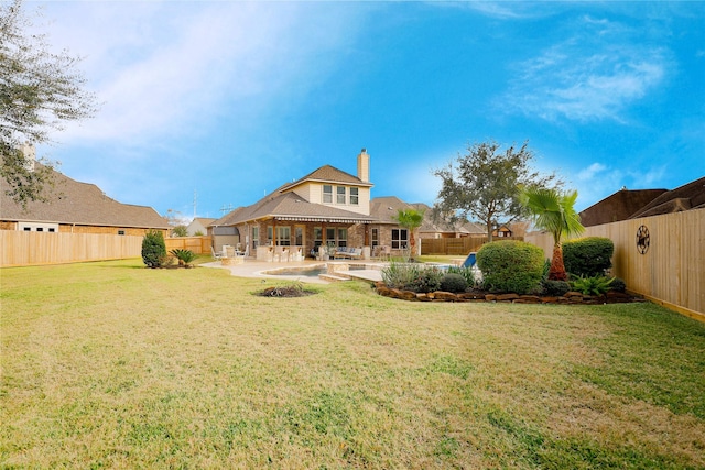 rear view of property featuring a yard and a patio