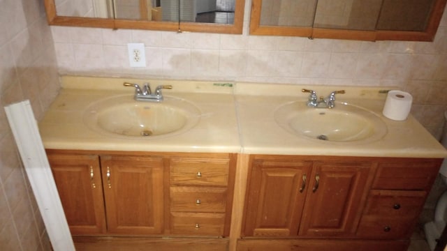 bathroom with tasteful backsplash and vanity