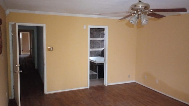 unfurnished bedroom with ceiling fan, dark wood-type flooring, and crown molding