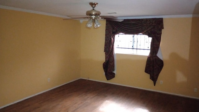 spare room with dark hardwood / wood-style floors, ceiling fan, and ornamental molding