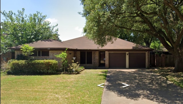 single story home with a front yard and a garage