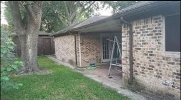 view of side of property with a lawn