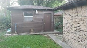 doorway to property featuring a lawn