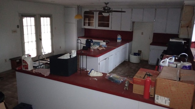 kitchen featuring white cabinets, ceiling fan, and kitchen peninsula