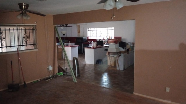 interior space with ceiling fan