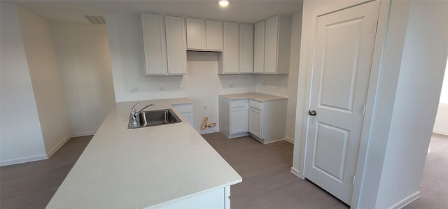 kitchen featuring light hardwood / wood-style floors, sink, and white cabinets