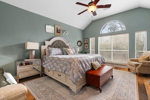 bedroom featuring ceiling fan, hardwood / wood-style flooring, and lofted ceiling