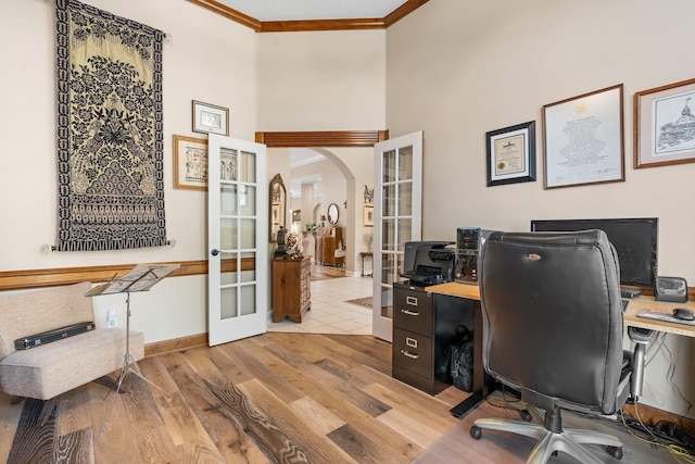 office area with light hardwood / wood-style floors, ornamental molding, and french doors