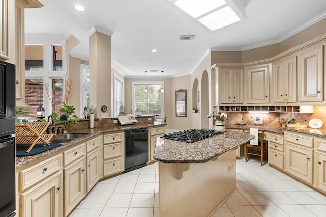 kitchen with kitchen peninsula, a breakfast bar area, dark stone counters, a kitchen island, and black appliances