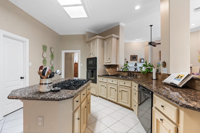 kitchen featuring black appliances, kitchen peninsula, light tile patterned floors, dark stone counters, and cream cabinets