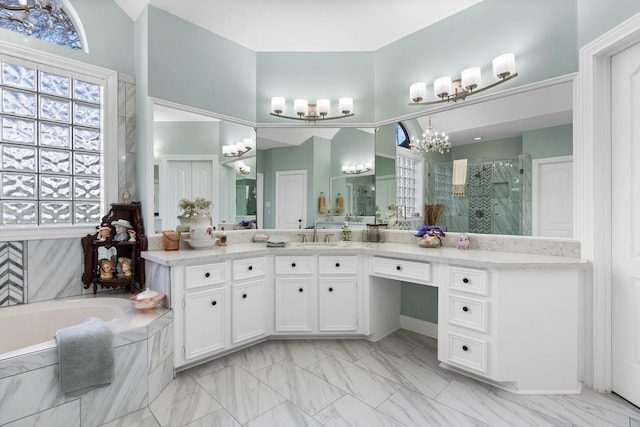 bathroom with vanity, independent shower and bath, and a chandelier