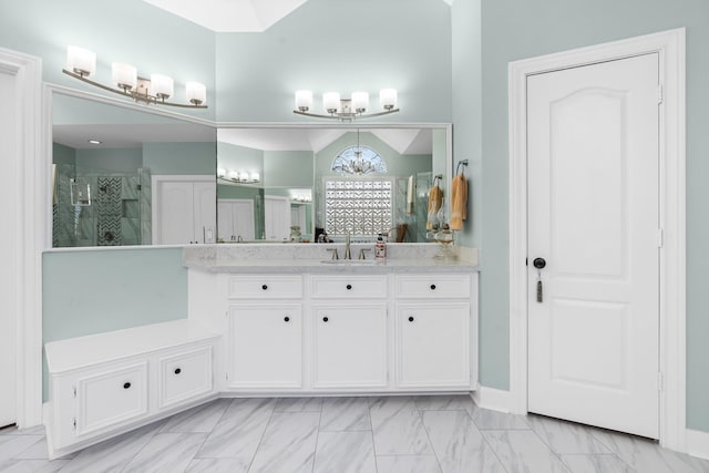 bathroom with vanity, an enclosed shower, and a notable chandelier