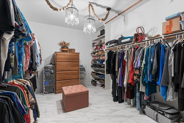 spacious closet with a chandelier