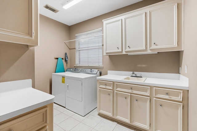 washroom with light tile patterned flooring, cabinets, washer and dryer, and sink